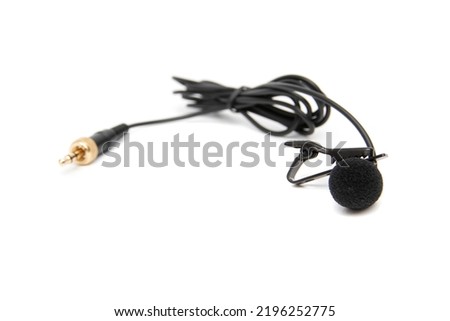 Lavalier microphone, isolated on white background. Selective focus. A lavalier microphone (also called a lavalier , clip-on microphone, or personal microphone).