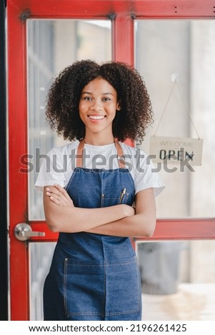 African American Female Small Business Owners Standing at the entrance to the coffee shop, leaning against the door with an open sign. SME entrepreneurs business