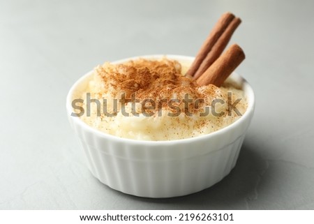 Delicious rice pudding with cinnamon on light table, closeup Royalty-Free Stock Photo #2196263101
