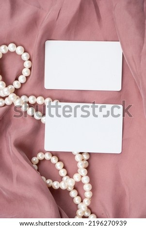 Pearl jewellery and pink silk styled stock scene, for wedding invitation, product showcase or styled presentation with copy space, top view