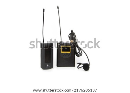 UHF Wireless, rechargeable lavalier microphone system with one transmitter and one receiver, isolated on white background. Ideal for vloggers.