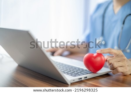 Doctor hands holding red heart, health care, love, organ donation, mindfulness, wellbeing, family insurance and CSR concept, world heart day, world health day, National Organ Donor Day, 