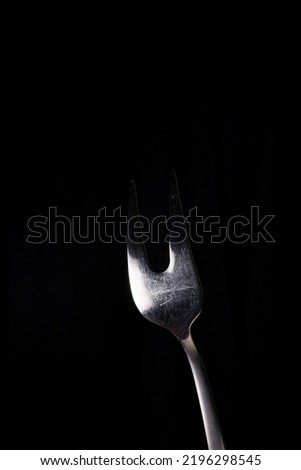 a fork on a black background
