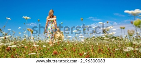 woman in a meadow with colorful flowers