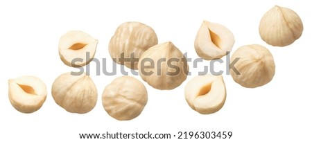 Peeled hazelnuts isolated on white background. Flying nuts. Diagonal layout. Package design element with clipping path