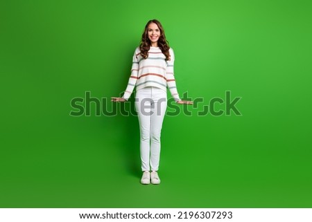 Full length photo of pretty girlish lady wear striped sweater smiling isolated green color background