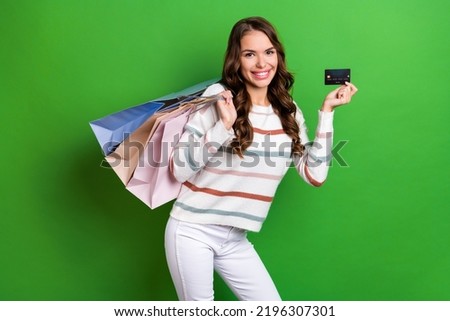 Photo of sweet charming girl dressed striped pullover rising bank card shoppers isolated green color background