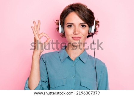 Photo portrait of charming young woman headset support agent show okey sign wear stylish blue garment isolated on pink color background