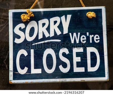 Sorry Were Closed sign in a window. Royalty-Free Stock Photo #2196316207