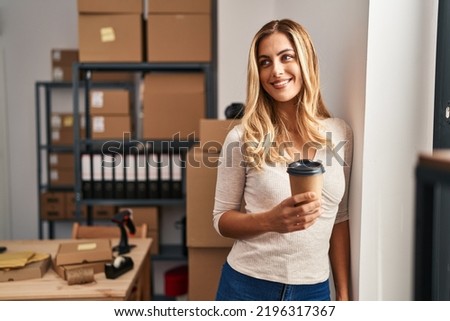 Young blonde woman ecommerce business worker drinking coffee at office