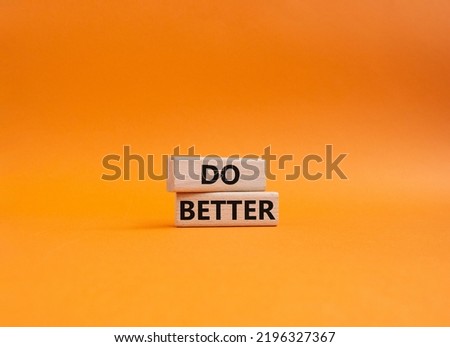Do better symbol. Wooden blocks with words Do better. Beautiful orange background. Business and Do better concept. Copy space.
