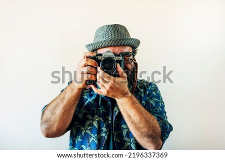 Fat man with a beard and taking pictures.
