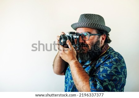 Fat man with a beard and taking pictures.