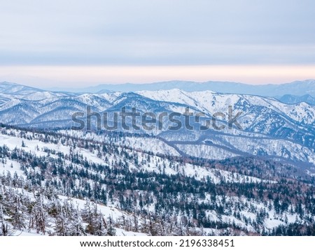 View of Mount Hachimantai with white snow foreground with blue sky in Tohoku, Japan. Mount Iwate Royalty-Free Stock Photo #2196338451