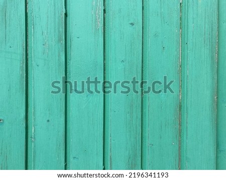 a light green painted washed out plank wall