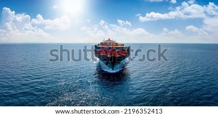 Aerial front view of a container cargo vessel traveling over the ocean with copy space as a banner for import and export industry