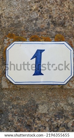 Amazing door number 1 blue color on white in the wall