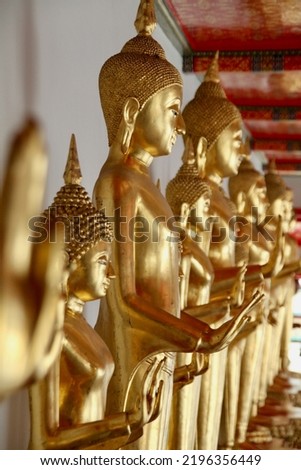 Golden buddah statures from the side