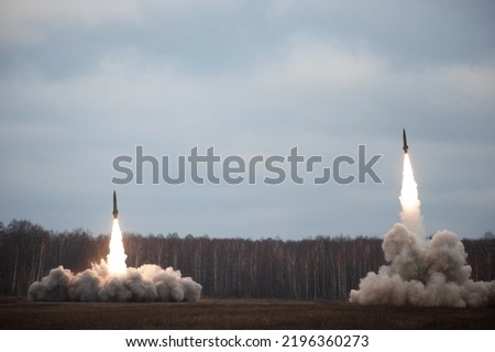 Launch of military missiles (rocket artillery) at the firing field during military exercise Royalty-Free Stock Photo #2196360273