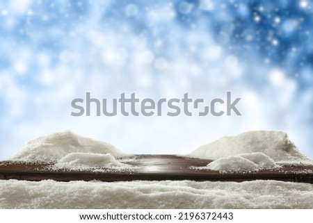 Wooden desk cover of snow and winter ladnscape. 