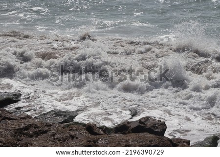 Moroccan atlantic coast. Beautiful clean sea with waves foam and brown rough rocks. Agadir region in Morocco.