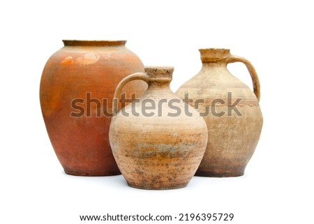 Antique ceramic decorative amphora on a white background. Clay jugs and a pot, a set of ancient utensils for drinking wine, water or milk. Royalty-Free Stock Photo #2196395729