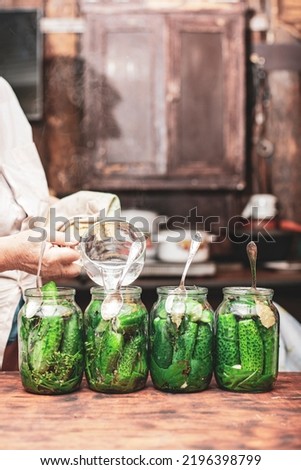 grandmother preparing stocks of pickles to avoid hunger, the background is blurred