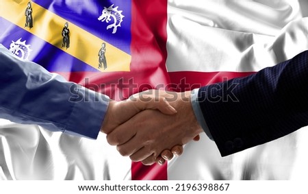 Handshake friendship Herm flag waving Celebration, Beautifully waving flag Close up of flag.
