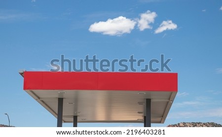 Red roof of gas station with blue sky background. Gasoline in USA. 