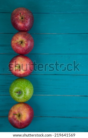 Farm fresh organic red and green apples on wooden table in pastel color with copy space in background
