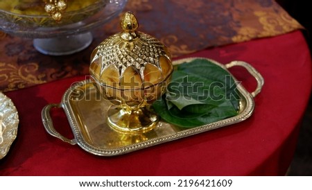 TEPAK SIRIH PINANG, a gold jar to put betel and areca nut in the traditional welcoming of guests in Indonesia Royalty-Free Stock Photo #2196421609