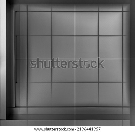 Architectural panels. Metal tile structure of wall. Mininal fragment of modern building. Industrial architecture photo. Hi-tech material background. Rectangular geometric pattern. Checkered structure.