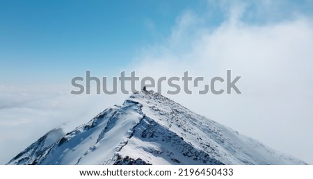 aerial landscape of snow mountain peak above clouds under the blue sky with a lot of copy space Royalty-Free Stock Photo #2196450433