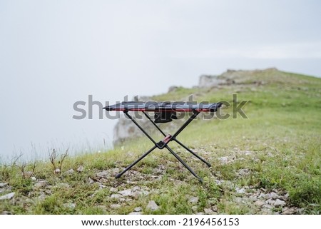 Small size frame table for camping, furniture made of light materials, trekking in the mountains, table for eating, tourist equipment. High quality photo