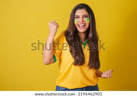 Woman supporter of Brazil, soccer championship, celebrating for victory, happy and smiling celebrating.