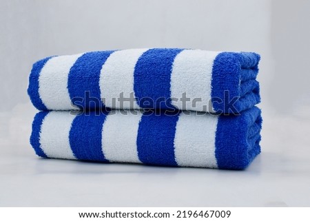 two cabana beach blue stripe cotton terry towel folded isolated Royalty-Free Stock Photo #2196467009