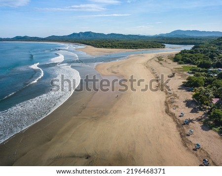 Playa Tamarindo, Guanacaste, Costa Rica - Aerial Drone shot of Tamarindo Beach and Playa Grande - most famous Surfing paradise on the Pacific Coast devided by River Estuary