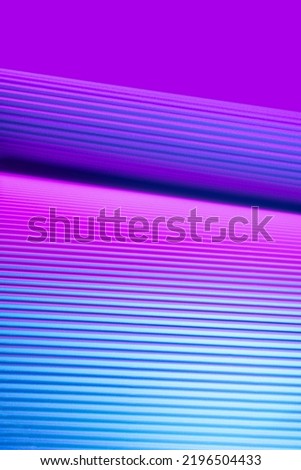 Violet and pink illuminated corrugated shapes. Geometric abstract background. Royalty-Free Stock Photo #2196504433