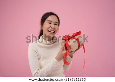 Celebration holiday, Presents. Young asian woman happy and smile hold gift boxes in party for celebrating birthday on pink background, Enjoy female receive new year gift, christmas day, valentine day.