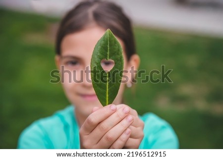 Children take care of nature tree in their hands. Selective focus. Love. Royalty-Free Stock Photo #2196512915