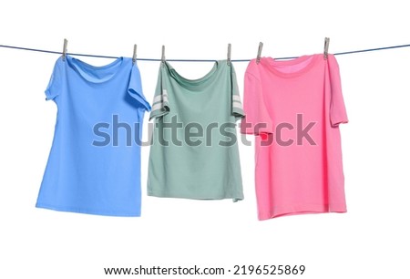 Different clothes drying on washing line against white background Royalty-Free Stock Photo #2196525869