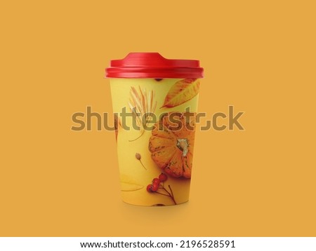 Takeaway cup for drink with print of autumn leaves and pumpkin on orange background