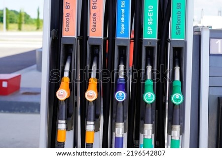 gas pump french text sign green yellow orange blue color fuel gasoline dispenser background