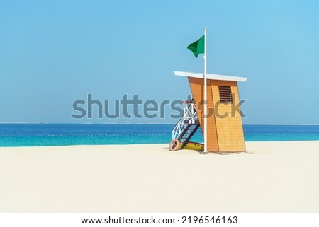 Lifeguard tower on a deserted white beach. Copy space