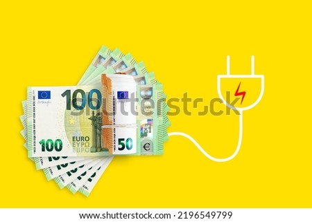 Euros banknotes on a yellow background. Energy crisis and expensive electricity, gas price. Big heating, gas and electricity bill Royalty-Free Stock Photo #2196549799