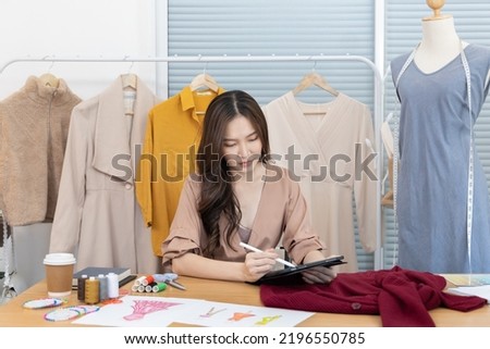 Professional female designer sketching outfits through tablet in the design studio, Fashion designer, Creativity and ideas, Mannequin, Shirt sketch, Color scheme, Garment accessories ,Freelance.