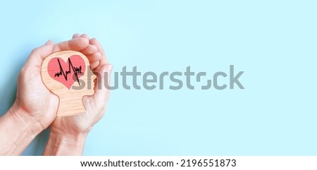 Hands holding wooden brain and heart, brain stroke, world heart day, world mental health day, Alzheimer concept. Royalty-Free Stock Photo #2196551873