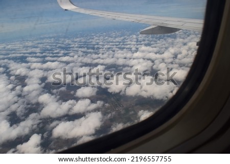 view of the clouds in the sky from the airplane window