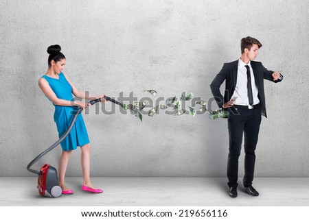 Woman vacuuming money out of man's pocket Royalty-Free Stock Photo #219656116