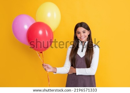 kid smile with party colorful balloons on yellow background